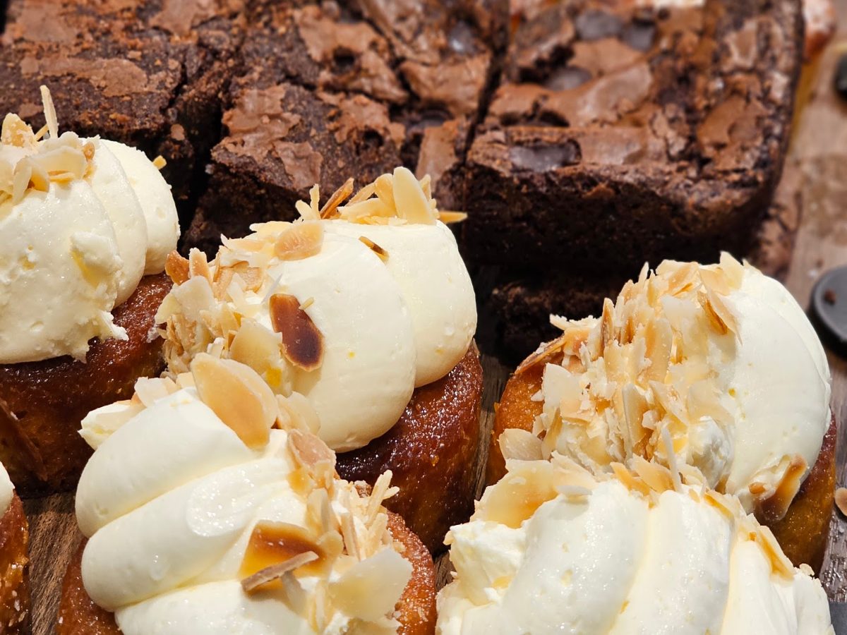 Brownies and almond traybakes with cream and toasted almonds in Alto's cake case.